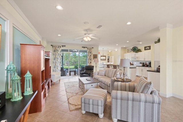 living room featuring ceiling fan and light tile patterned floors