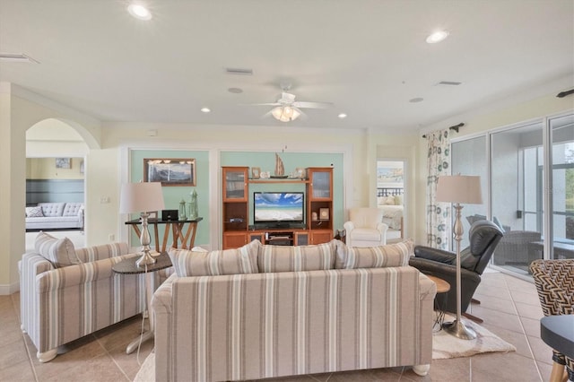 tiled living room featuring plenty of natural light and ceiling fan