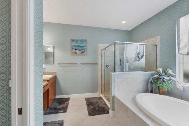 bathroom featuring tile patterned floors, vanity, and shower with separate bathtub