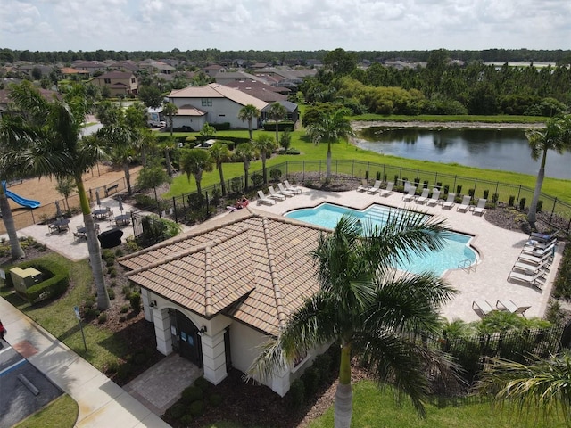 view of pool featuring a yard, a patio, and a water view