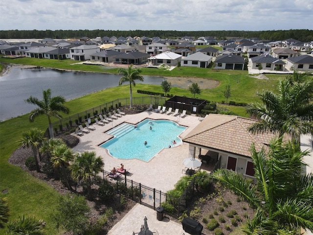 view of pool featuring a yard, a patio, and a water view