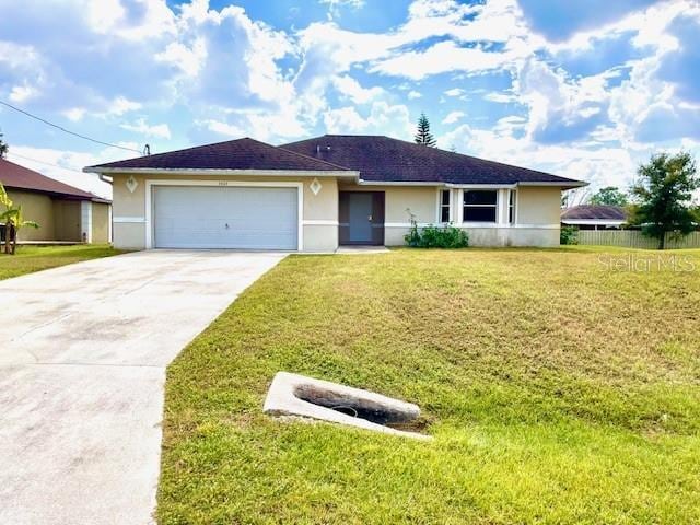 ranch-style home with a garage and a front lawn