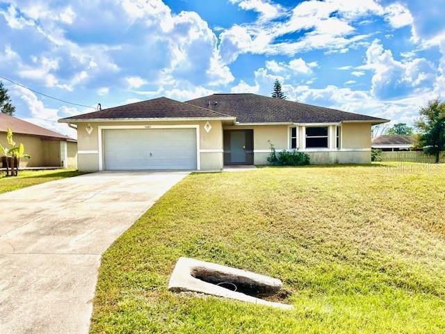 ranch-style home featuring a garage and a front lawn