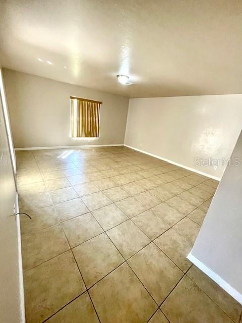 spare room featuring light tile patterned flooring