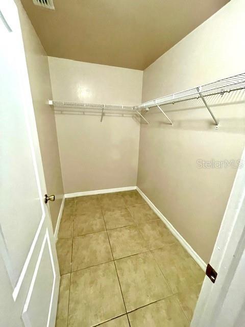 walk in closet with tile patterned flooring