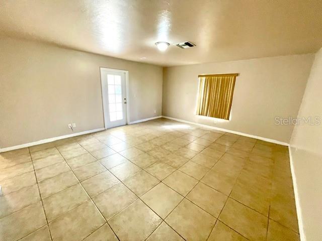 empty room with light tile patterned floors