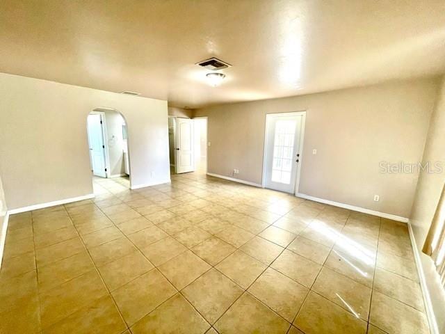 unfurnished room featuring light tile patterned floors