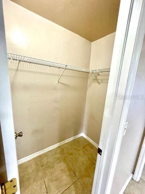 spacious closet featuring tile patterned floors