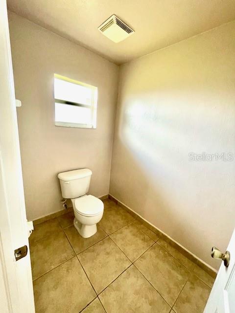 bathroom featuring tile patterned floors and toilet