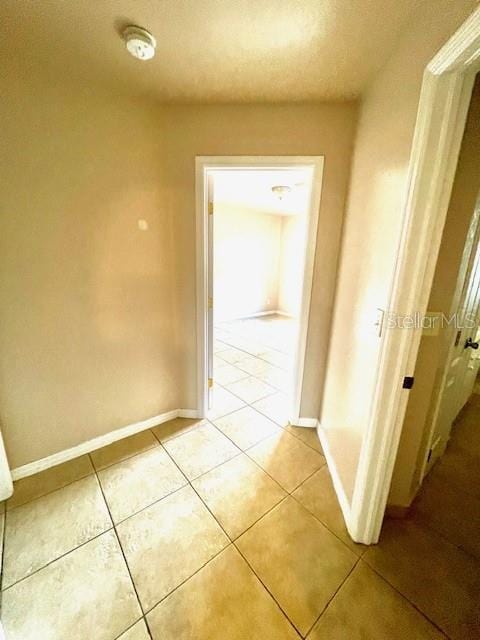 hallway featuring light tile patterned floors