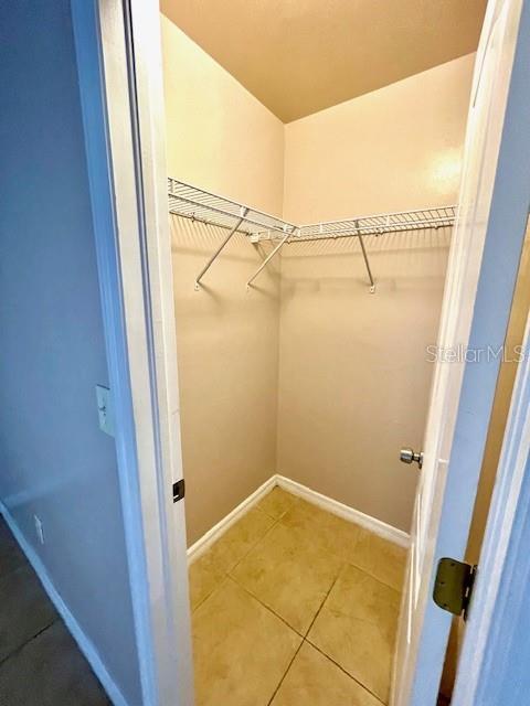 spacious closet featuring tile patterned floors