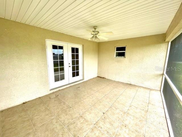 unfurnished sunroom featuring french doors and ceiling fan