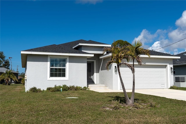 view of front of home with a garage and a front lawn