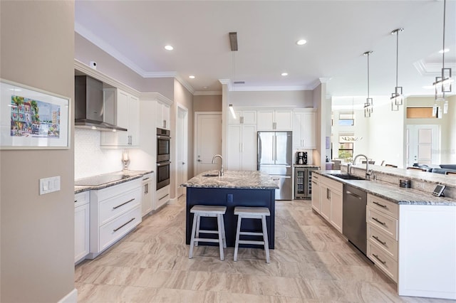 17122 Barcrest Ln, Punta Gorda, FL 33955 - kitchen featuring appliances with stainless steel finishes, wall chimney range hood, a spacious island, crown molding, and a breakfast bar area