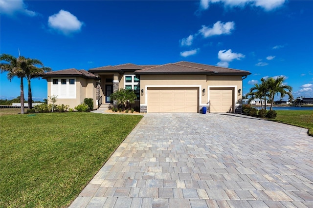 17122 Barcrest Ln, Punta Gorda, FL 33955 - prairie-style house with decorative driveway, an attached garage, stucco siding, and a front lawn
