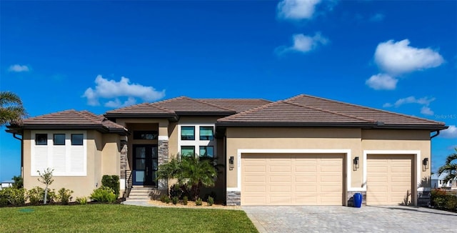 17122 Barcrest Ln, Punta Gorda, FL 33955 - prairie-style home featuring a garage, decorative driveway, stucco siding, and a front yard