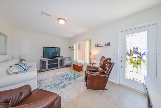 tiled living room with a wealth of natural light