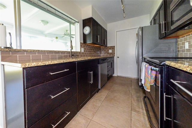 kitchen featuring light tile patterned flooring, appliances with stainless steel finishes, sink, and backsplash