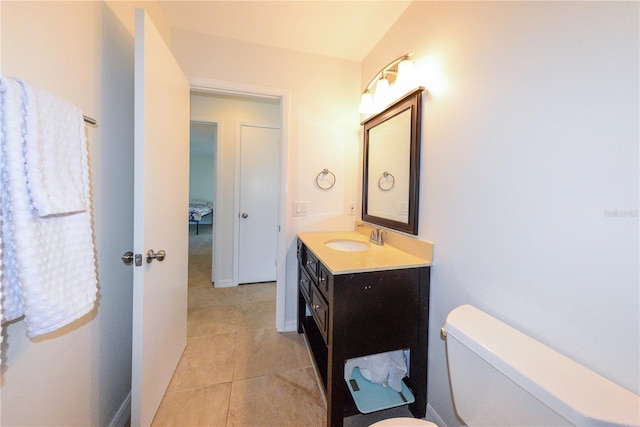 bathroom featuring tile patterned flooring, vanity, and toilet