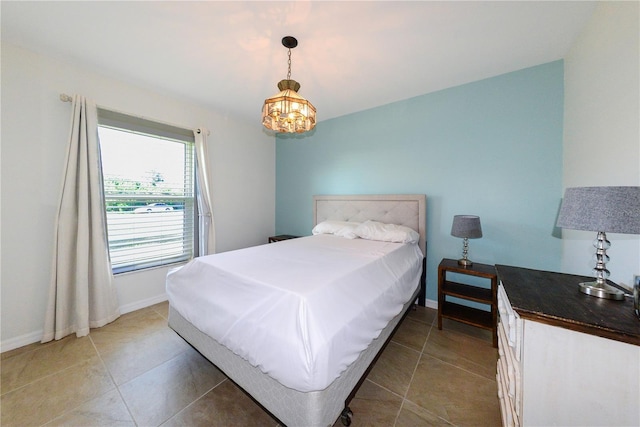 tiled bedroom featuring a notable chandelier