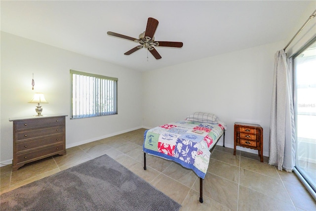 tiled bedroom with a baseboard radiator and ceiling fan