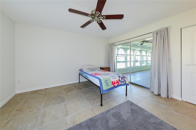 bedroom featuring access to exterior, light tile patterned floors, and ceiling fan