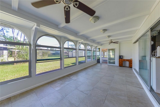 unfurnished sunroom with ceiling fan and beam ceiling