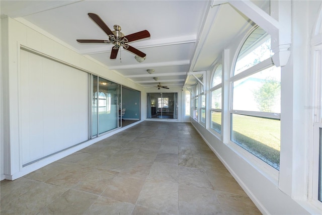 unfurnished sunroom with beam ceiling