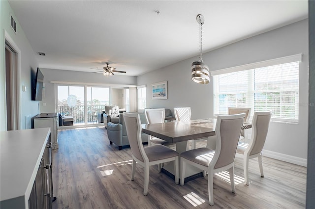 dining room with hardwood / wood-style flooring and ceiling fan