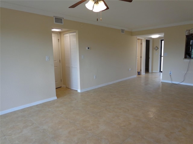 empty room featuring ornamental molding and ceiling fan