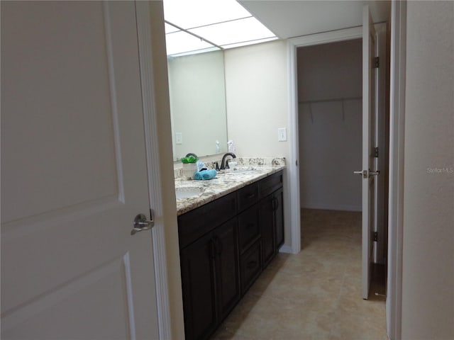 bathroom featuring vanity and a skylight