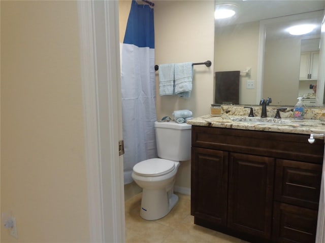 bathroom with vanity, tile patterned floors, toilet, and walk in shower