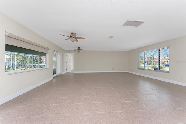 empty room with ceiling fan and light tile patterned flooring