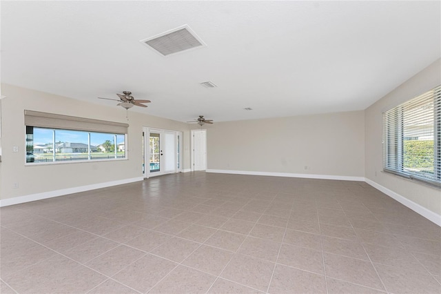 tiled spare room featuring ceiling fan