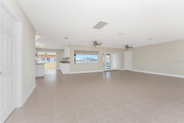 unfurnished living room featuring light tile patterned flooring and ceiling fan