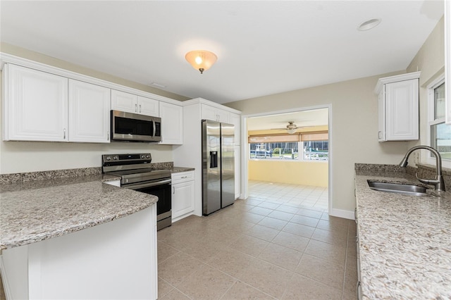 kitchen with white cabinetry, sink, light tile patterned floors, ceiling fan, and stainless steel appliances