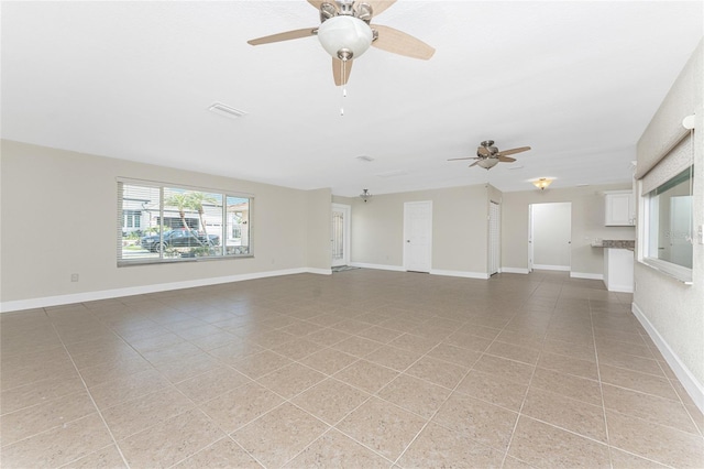 unfurnished living room with ceiling fan and light tile patterned floors