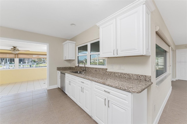 kitchen featuring white cabinetry, sink, light tile patterned floors, and stainless steel dishwasher