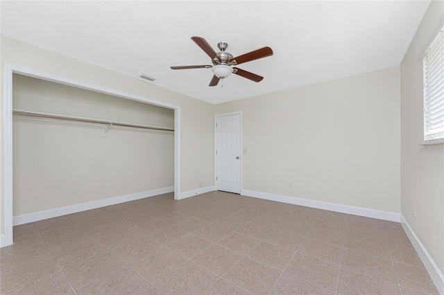 unfurnished bedroom with a closet and ceiling fan