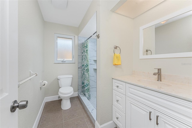 bathroom with vanity, tile patterned floors, toilet, and walk in shower