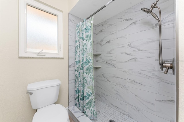 bathroom featuring toilet and curtained shower