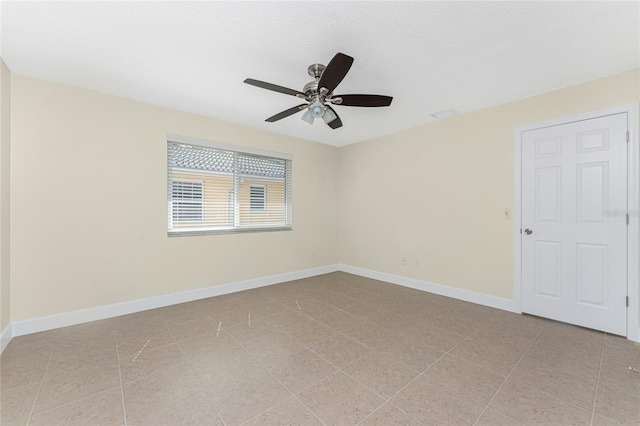 unfurnished room featuring light tile patterned floors, a textured ceiling, and ceiling fan