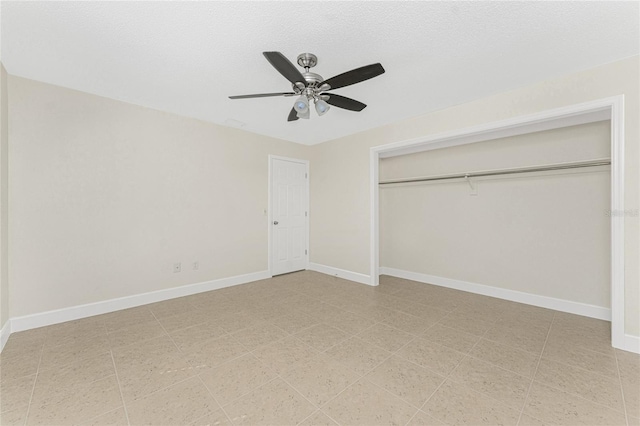 unfurnished bedroom with a textured ceiling, ceiling fan, and a closet