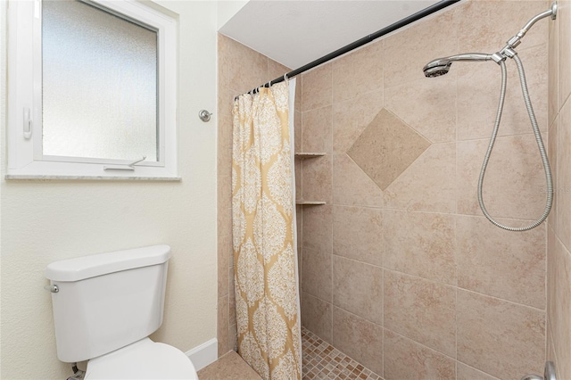 bathroom featuring toilet and a shower with curtain