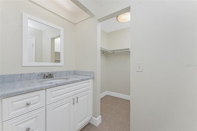 bathroom featuring tile patterned flooring and vanity