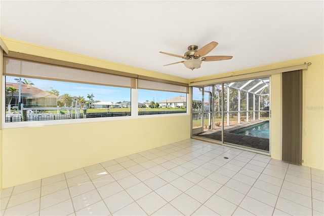 tiled empty room with ceiling fan