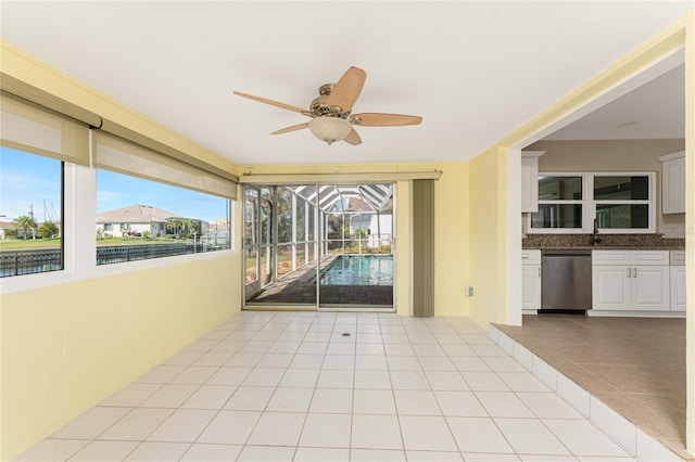 interior space featuring ceiling fan and a healthy amount of sunlight