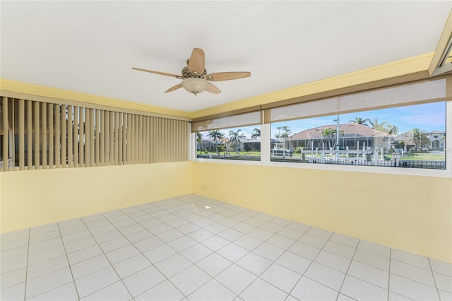 unfurnished sunroom featuring ceiling fan