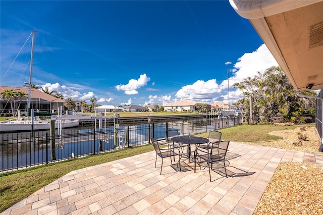 view of patio / terrace featuring a water view and a dock