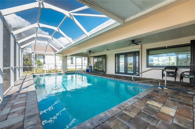 view of swimming pool with french doors, ceiling fan, a lanai, and a patio area